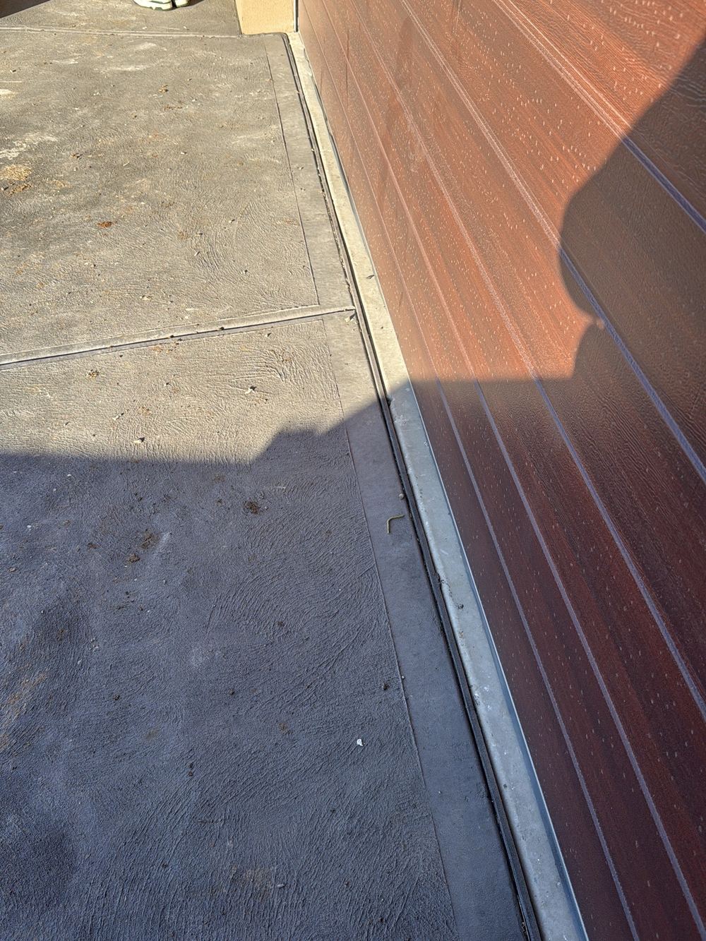 Isolation joints where the driveway meets the garage and walls left unsealed, found during a pre-handover (PCI) inspection in Beveridge
