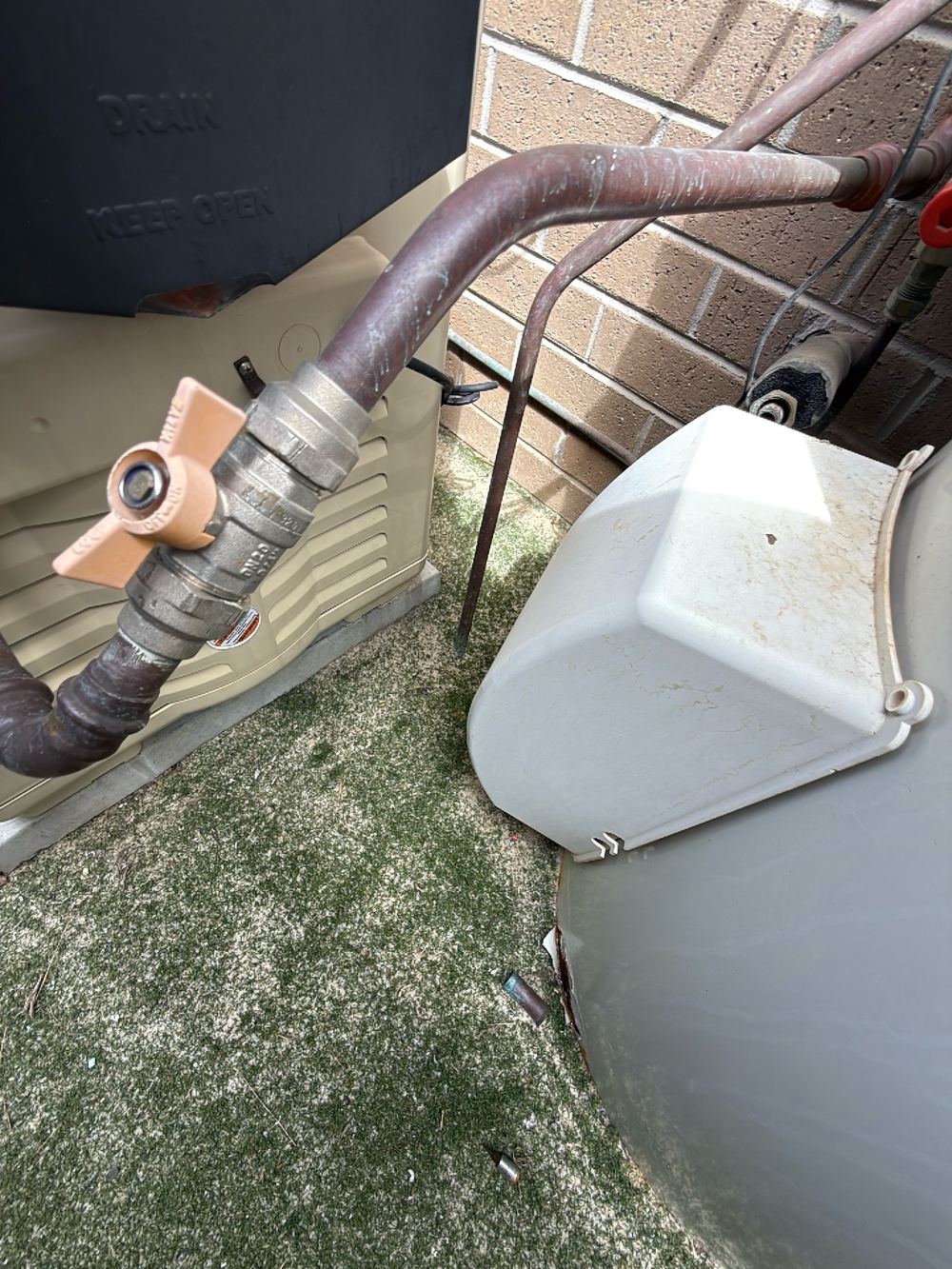 Hot water relief valve discharging right against the external wall, Doreen, Beveridge
